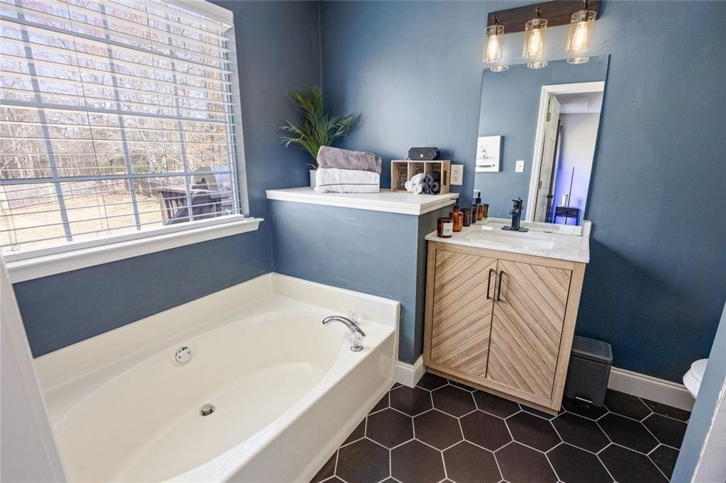 140 Mt Tabor Court Dallas, GA 30157 - Photo 15 of 32 a bathroom with a tub sink and mirror