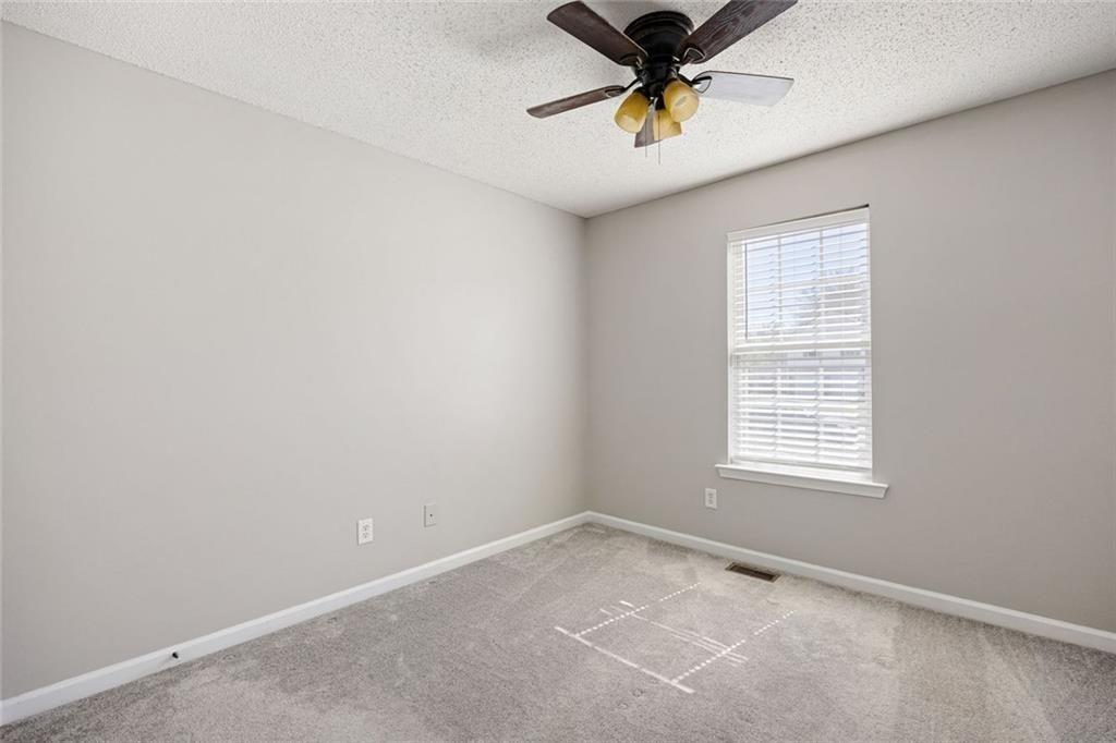 140 Mt Tabor Court Dallas, GA 30157 - Photo 18 of 32 an empty room with a window and a fan
