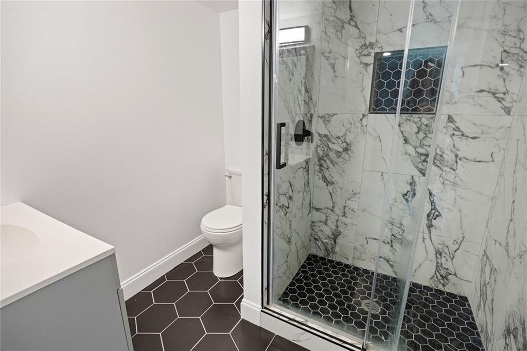 140 Mt Tabor Court Dallas, GA 30157 - Photo 24 of 32 a bathroom with a toilet and a shower