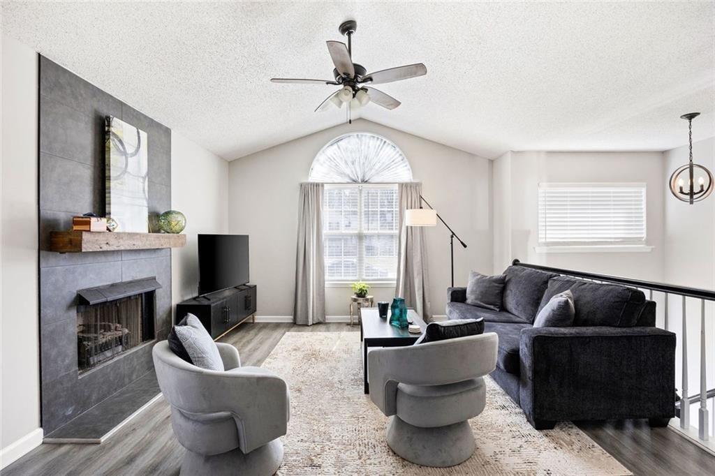 140 Mt Tabor Court Dallas, GA 30157 - Photo 5 of 32 a living room with furniture a fireplace and a large window