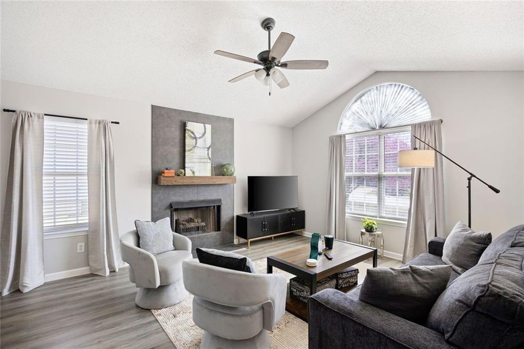 140 Mt Tabor Court Dallas, GA 30157 - Photo 6 of 32 a living room with furniture a fireplace and a flat screen tv