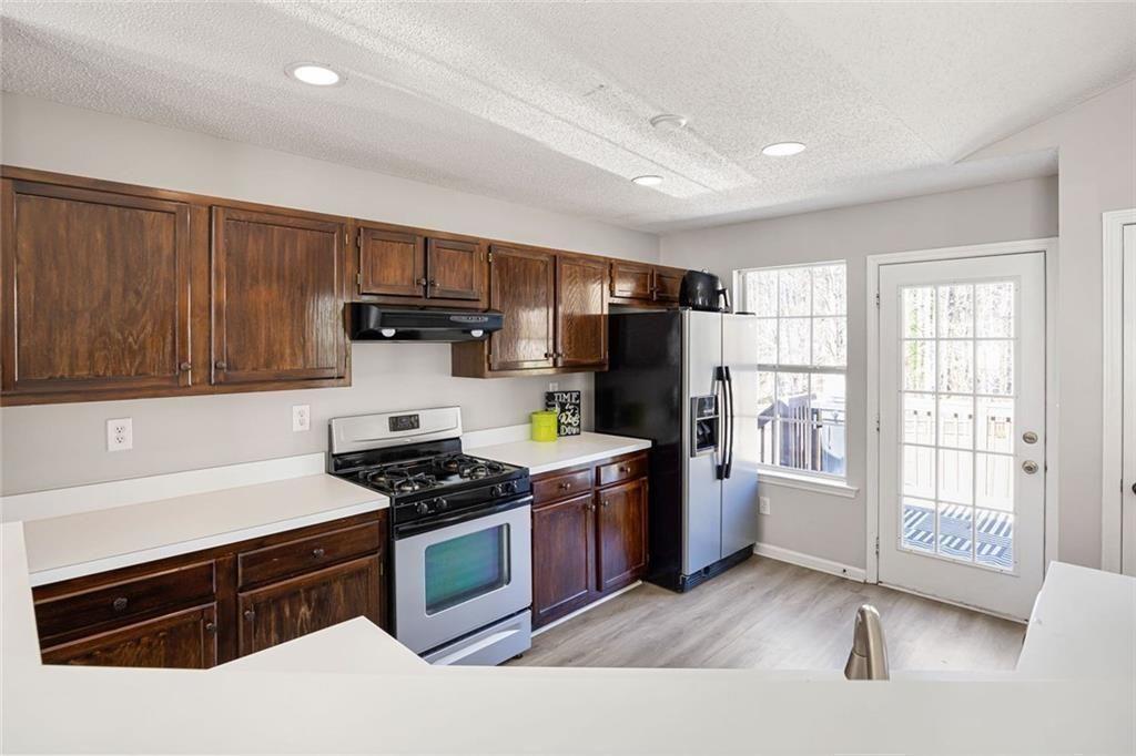 140 Mt Tabor Court Dallas, GA 30157 - Photo 9 of 32 a kitchen with stainless steel appliances granite countertop a stove and a refrigerator