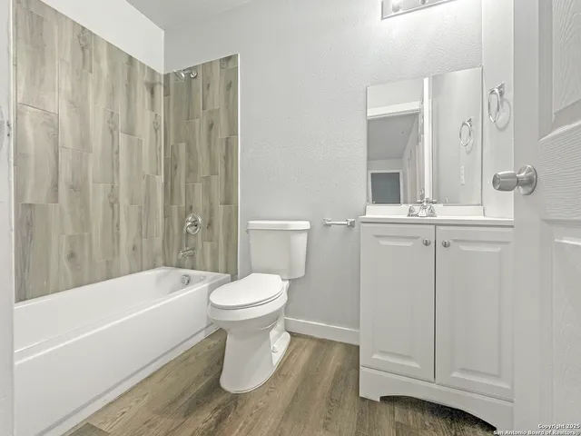 a bathroom with a toilet and a bathtub