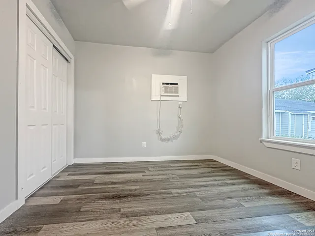 a view of a room with wooden floor and windows