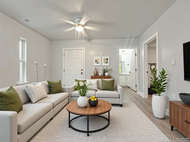 a living room with furniture and a chandelier