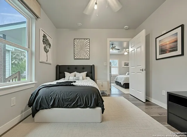 a bedroom with a large bed and a window