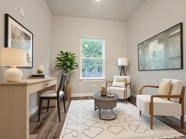a living room with furniture a table and a potted plant