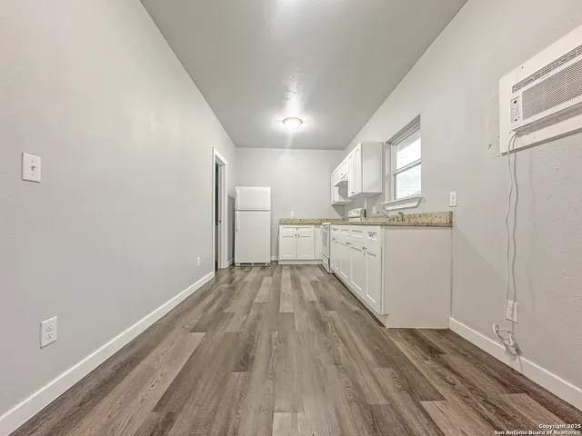 a view of a kitchen with a sink and cabinets