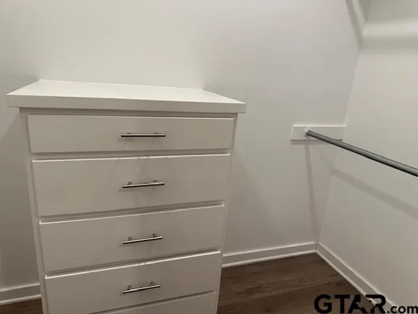 a bathroom with a toilet and a mirror