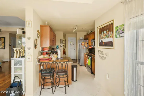 a dining room with furniture and a floor to ceiling window