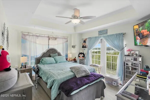 a bedroom with a large bed and a flat tv screen