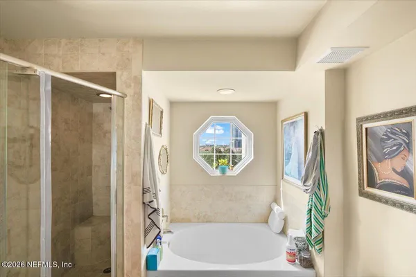 a bathroom with a bathtub and a shower