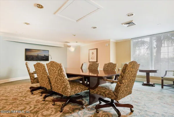 a living room with furniture a clock and a fireplace
