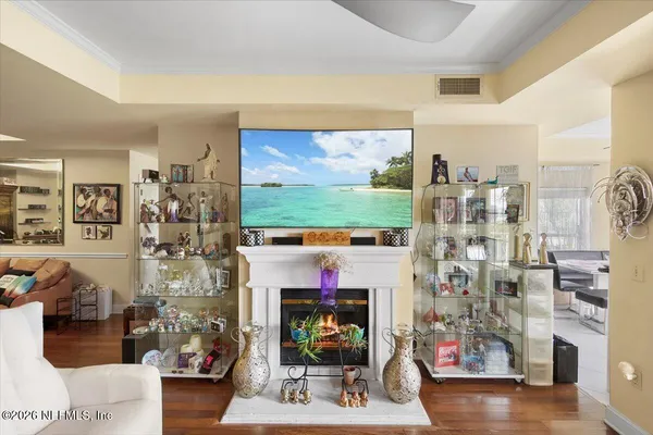 a living room with fireplace furniture and a flat screen tv
