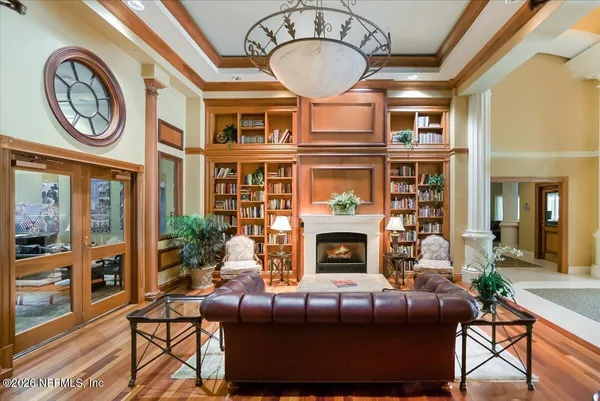 a living room with furniture and wooden floor