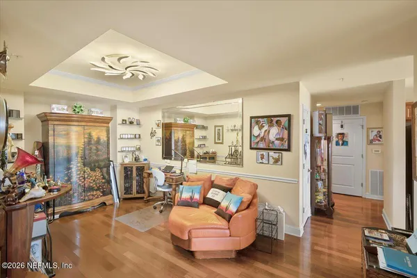 a living room with furniture and wooden floor