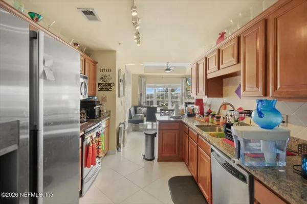 a kitchen with refrigerator and cabinets