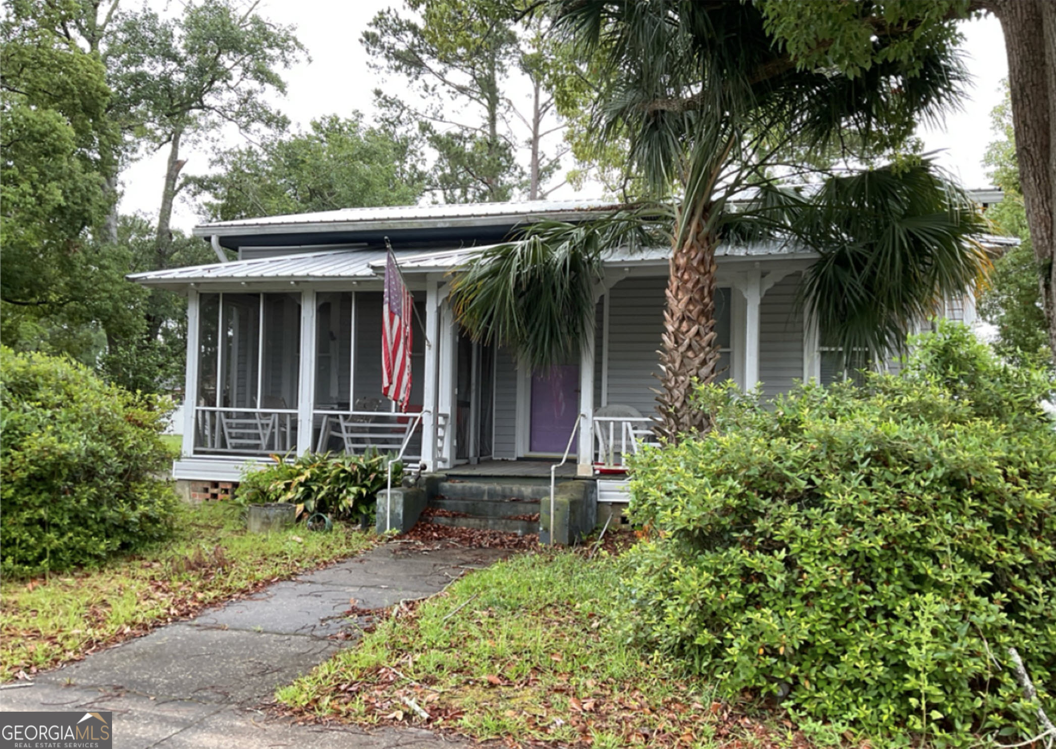 front view of a house with a garden