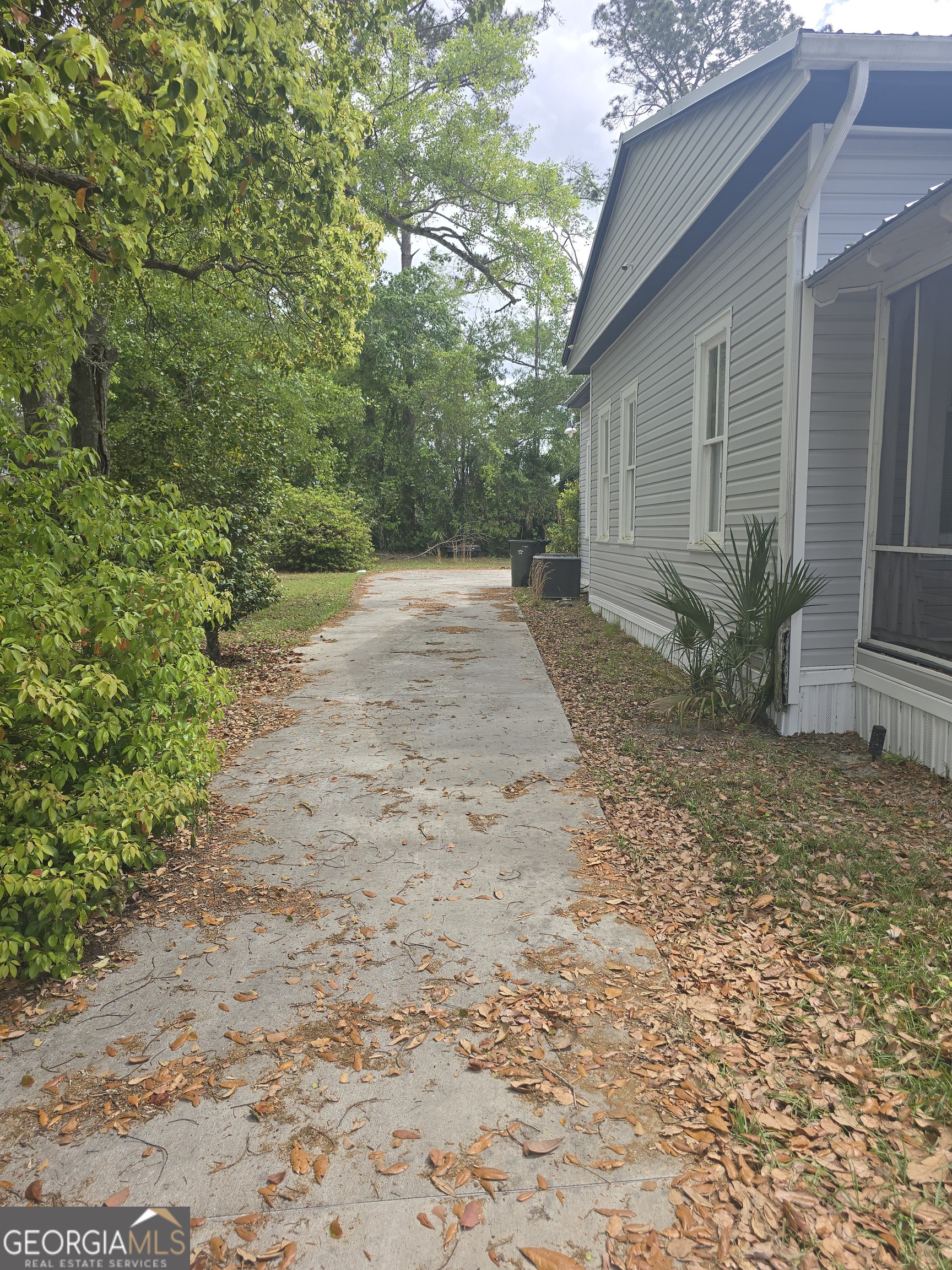1500 Clough Street Waycross, GA 31501 - Photo 4 of 12 a view of a yard with plants and trees