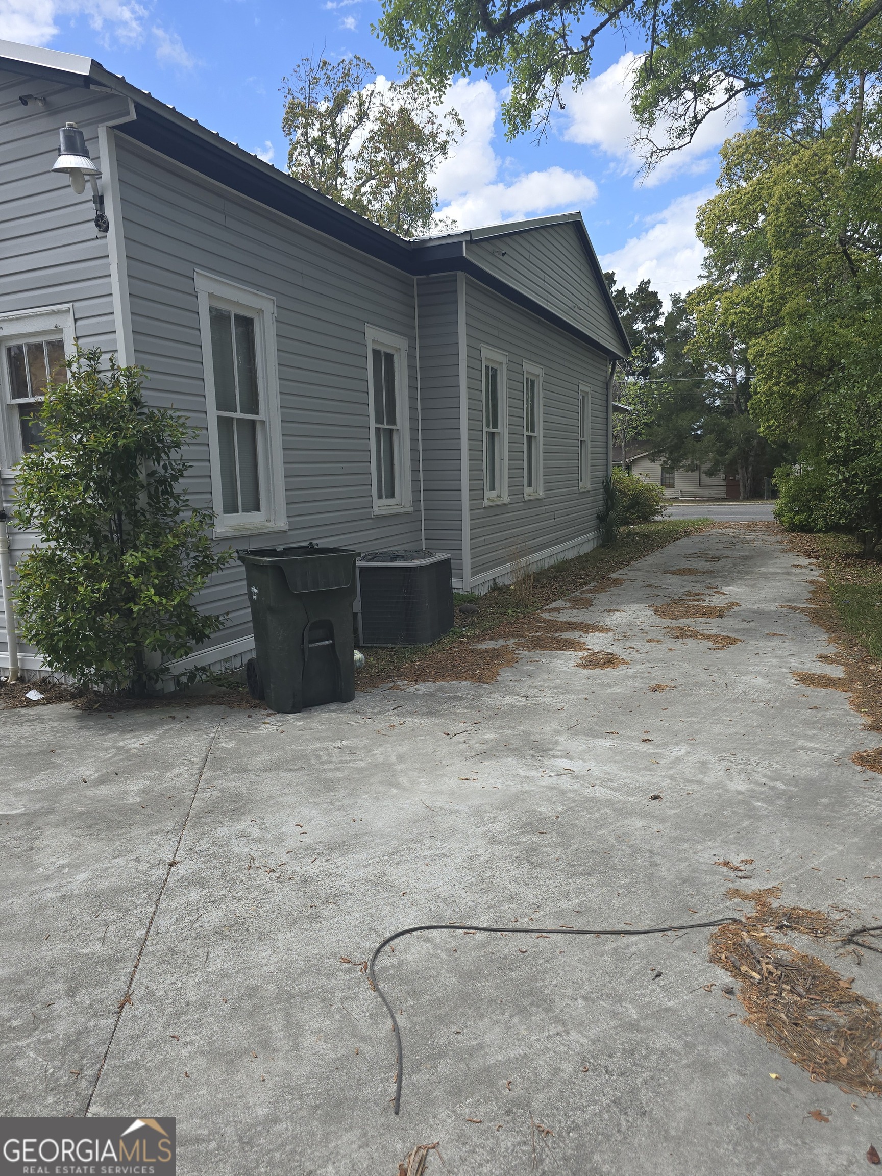 1500 Clough Street Waycross, GA 31501 - Photo 7 of 12 a backyard of a house with plants and trees