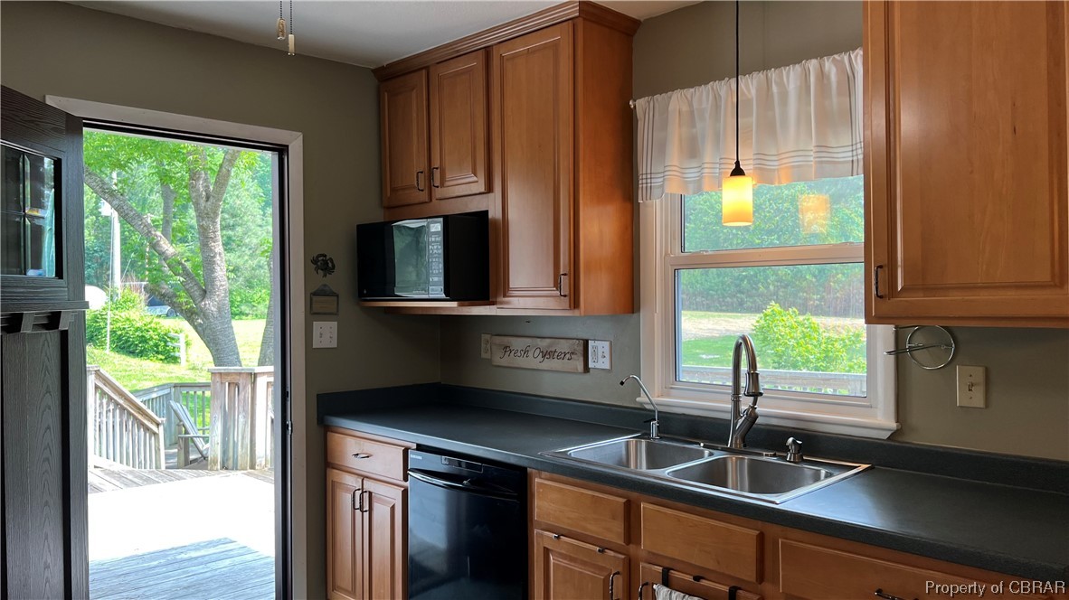 88 Leachwood Road Lancaster, VA 22503 - Photo 33 of 49 a kitchen with kitchen island granite countertop a sink a counter appliances and cabinets