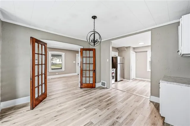 a kitchen with granite countertop a sink window and cabinets