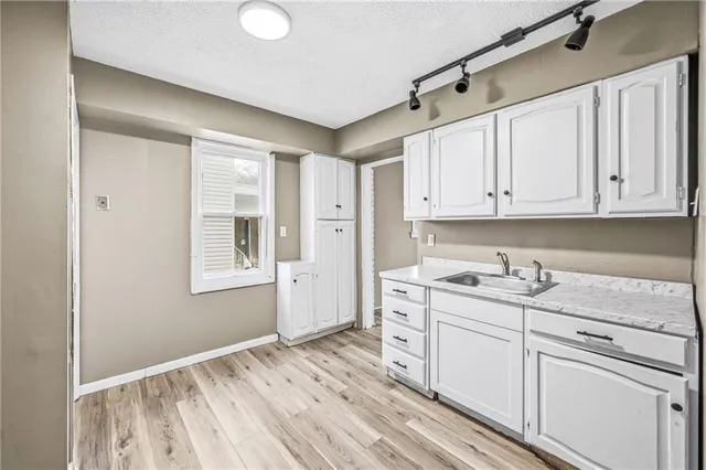 a kitchen with stainless steel appliances a refrigerator and a stove top oven