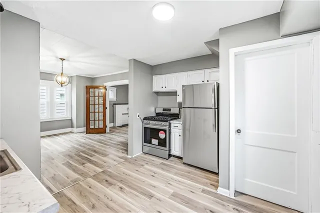 a kitchen with a refrigerator and a stove top oven