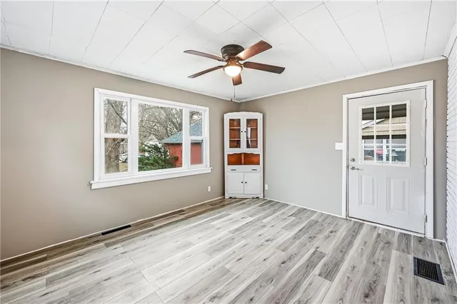 a view of empty room with wooden floor
