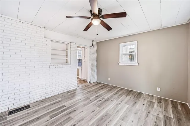 a view of staircase with wooden floor and white walls