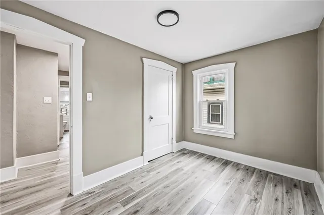a view of a room with wooden floor and bathroom