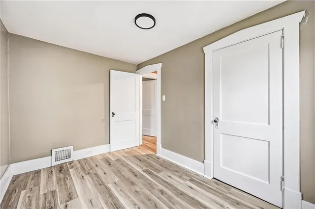 a view of room with wooden floor