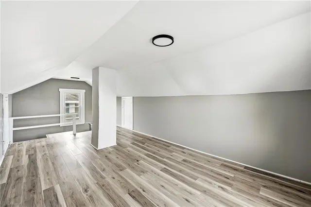a view of a room with wooden floor