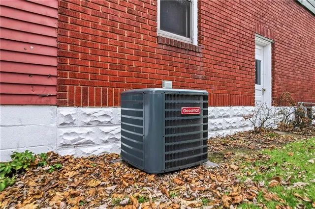 front view of a brick house with a yard
