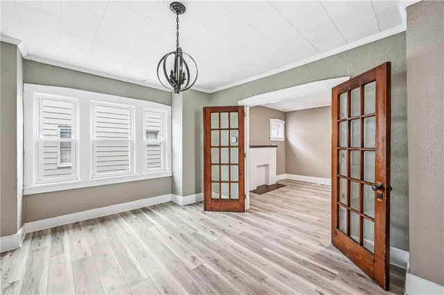 a view of empty room with wooden floor and window