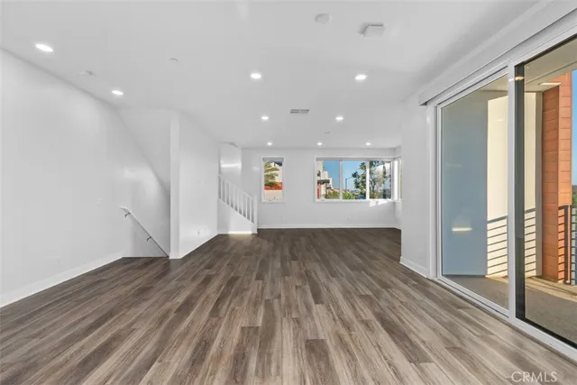 a view of an empty room and a window