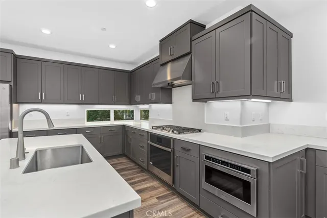 a kitchen with a sink cabinets and appliances