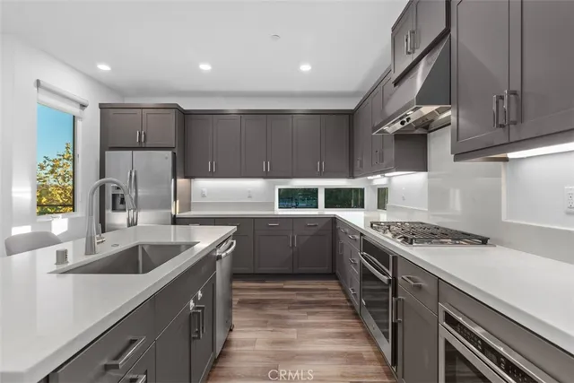a kitchen with a stove sink and cabinets