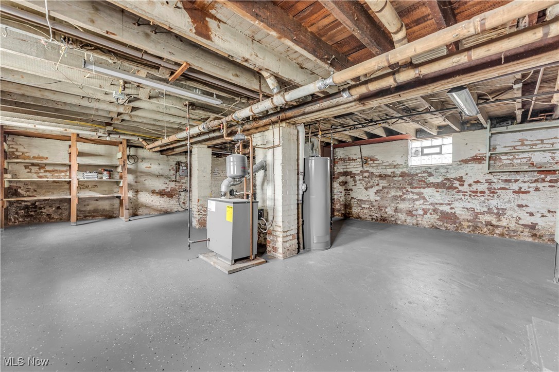 3374 Fulton Road Cleveland, OH 44109 - Photo 23 of 27 Below grade area with water heater and a heating unit