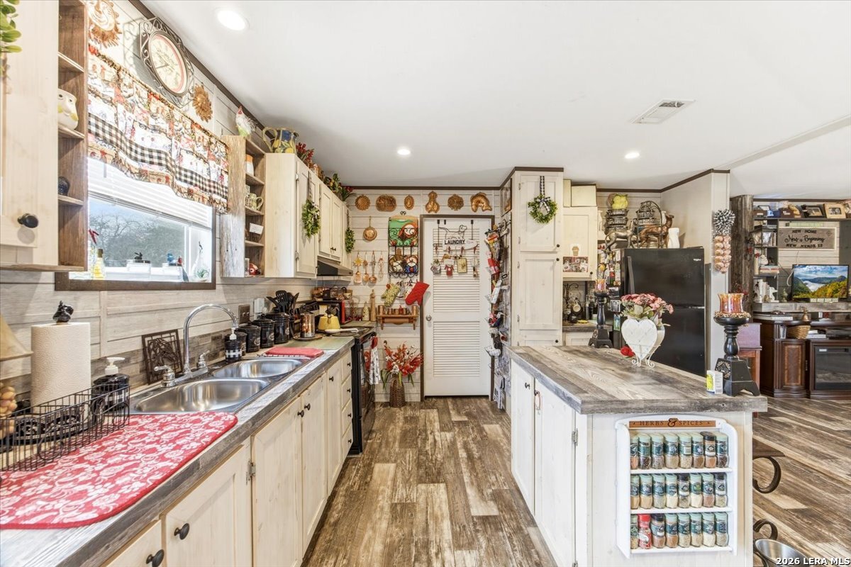 101 Rocky Ridge Drive Poteet, TX 78065 - Photo 12 of 36 a kitchen with a sink stove and cabinets