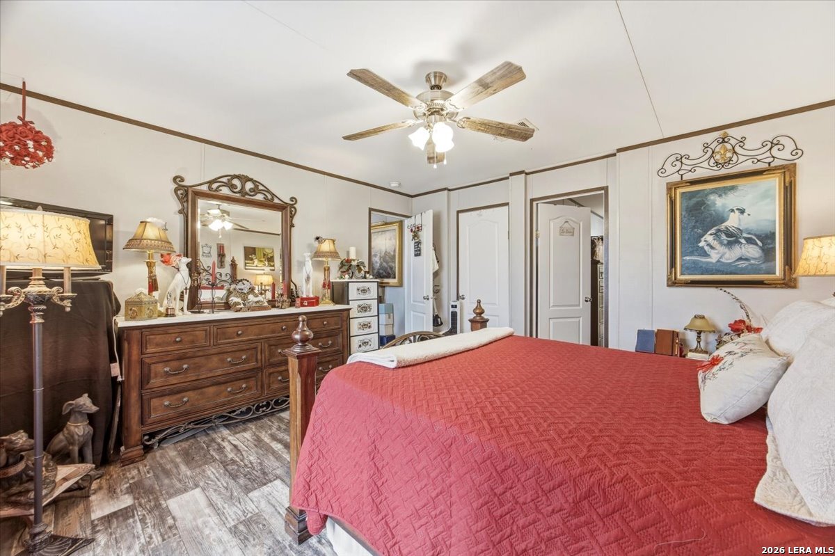 101 Rocky Ridge Drive Poteet, TX 78065 - Photo 19 of 36 a bedroom with a bed and ceiling fan