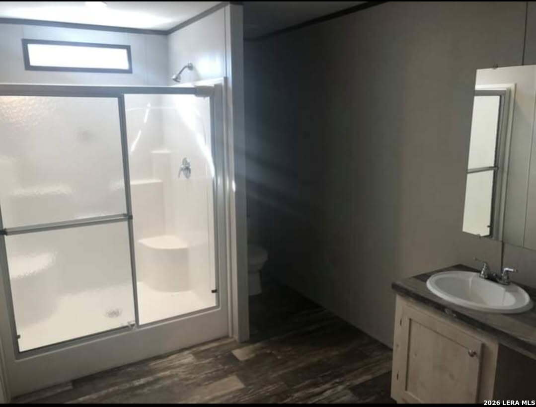 101 Rocky Ridge Drive Poteet, TX 78065 - Photo 21 of 36 a bathroom with a sink and a mirror