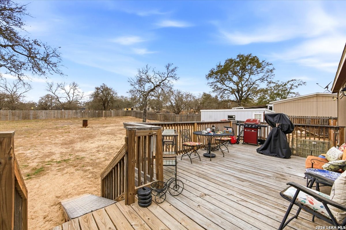 101 Rocky Ridge Drive Poteet, TX 78065 - Photo 27 of 36 a view of a balcony with chairs and wooden floor