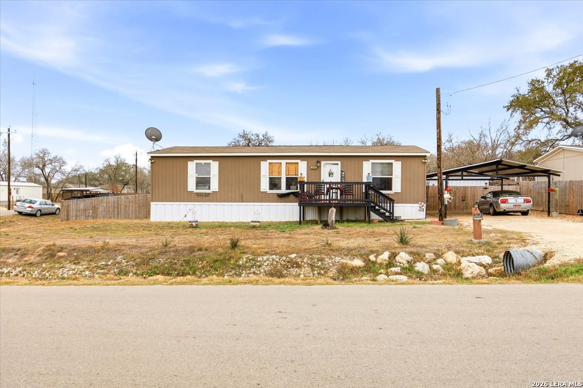 101 Rocky Ridge Drive Poteet, TX 78065 - Photo 4 of 36 a view of a house with a yard covered with snow in front of it