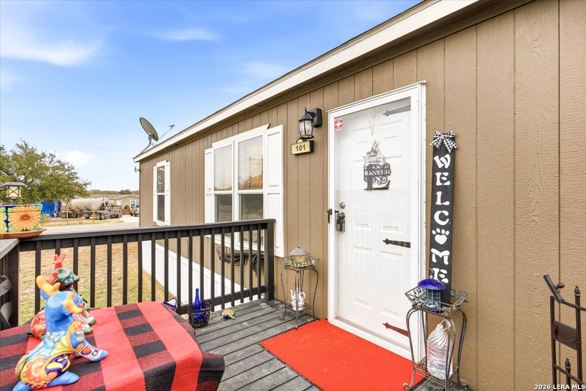 101 Rocky Ridge Drive Poteet, TX 78065 - Photo 5 of 36 a balcony with wooden floor table and chairs