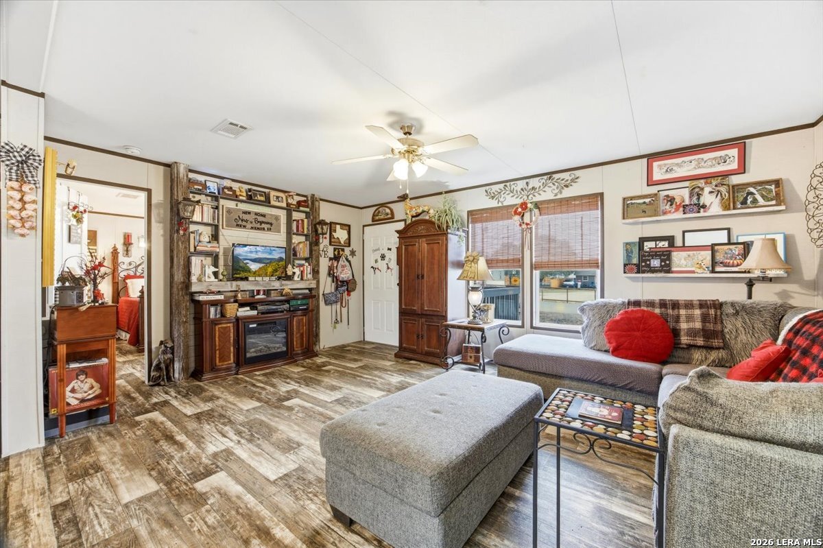 101 Rocky Ridge Drive Poteet, TX 78065 - Photo 7 of 36 a living room with furniture a flat screen tv and a floor to ceiling window