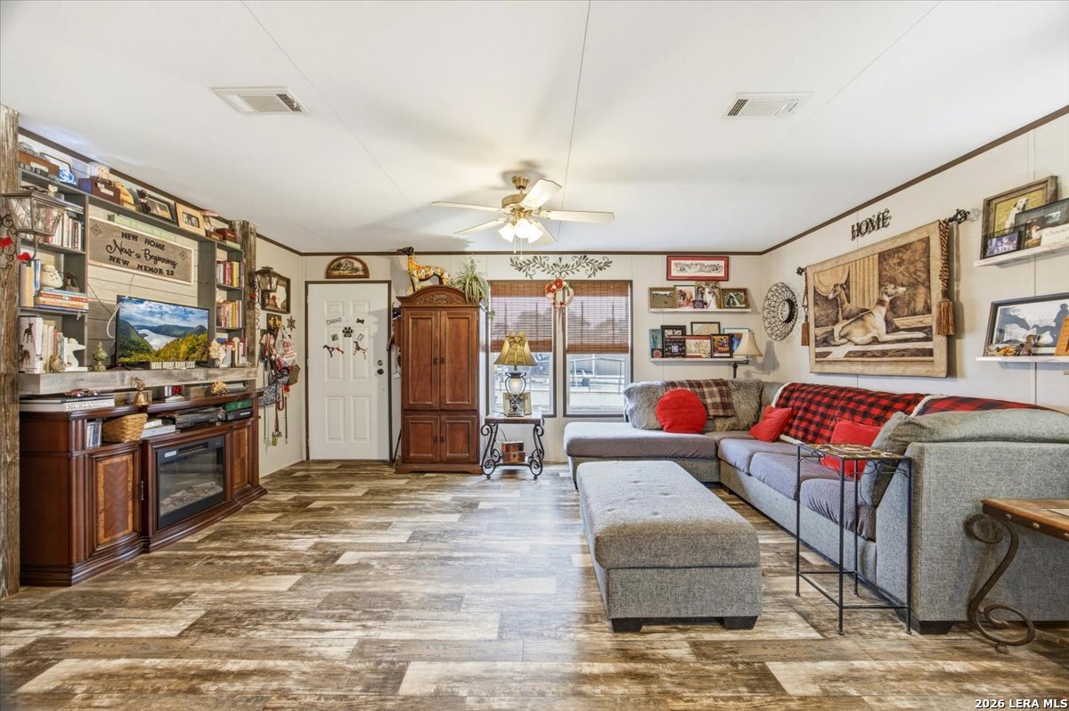 101 Rocky Ridge Drive Poteet, TX 78065 - Photo 9 of 36 a living room with furniture and chandelier