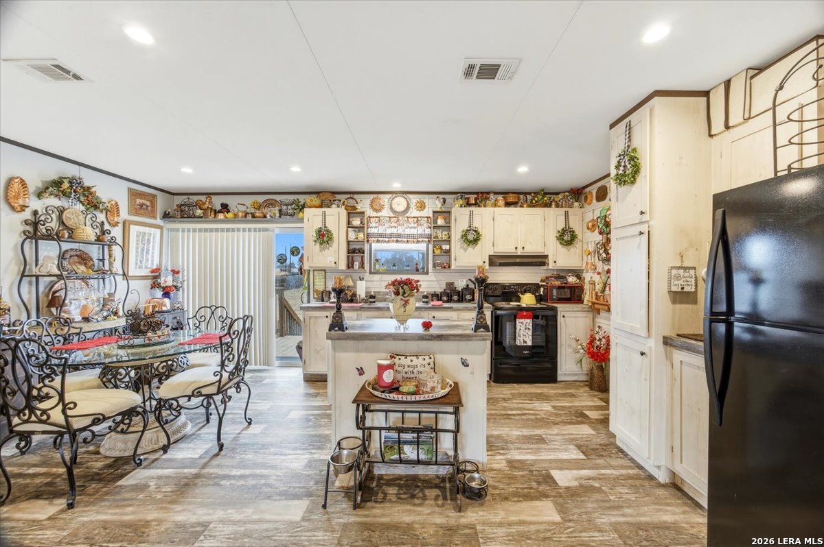 101 Rocky Ridge Drive Poteet, TX 78065 - Photo 10 of 36 a kitchen with stainless steel appliances kitchen island granite countertop a refrigerator and a stove