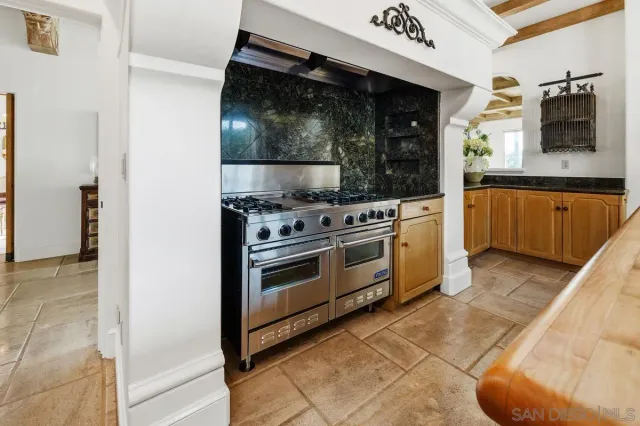 a kitchen with stainless steel appliances granite countertop a stove and a microwave