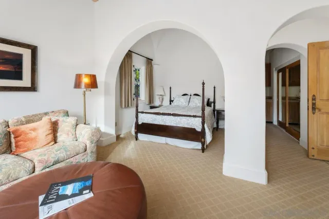 a living room with furniture and a lamp